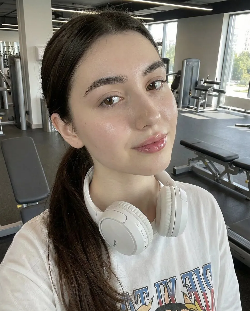 Young Woman in Gym Selfie with Headphones - Fitness Portrait - Portrait, Photography - AI Generated Image